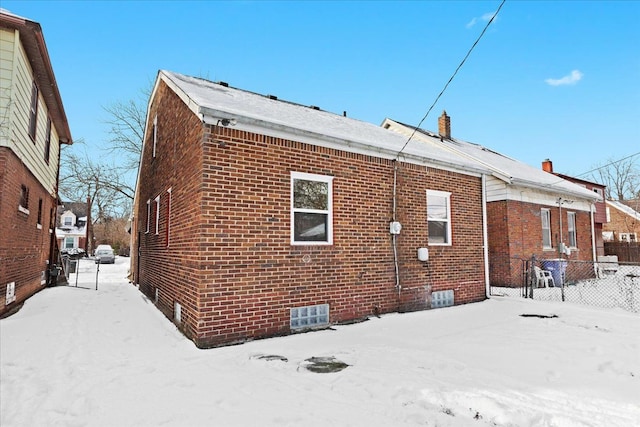 view of snow covered rear of property