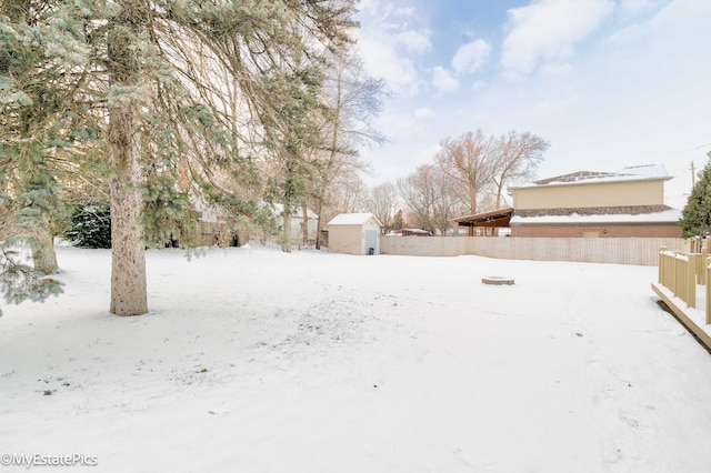 snowy yard with a storage unit