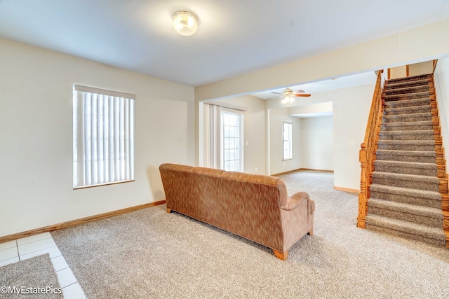 living room featuring ceiling fan, light tile patterned flooring, and plenty of natural light