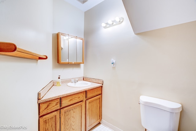 bathroom featuring toilet and vanity