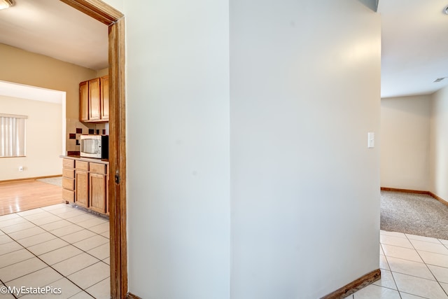 hallway with light tile patterned floors