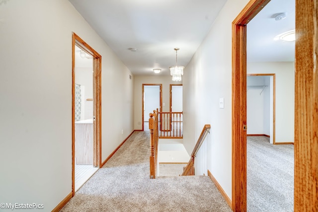 hall featuring a chandelier and light colored carpet