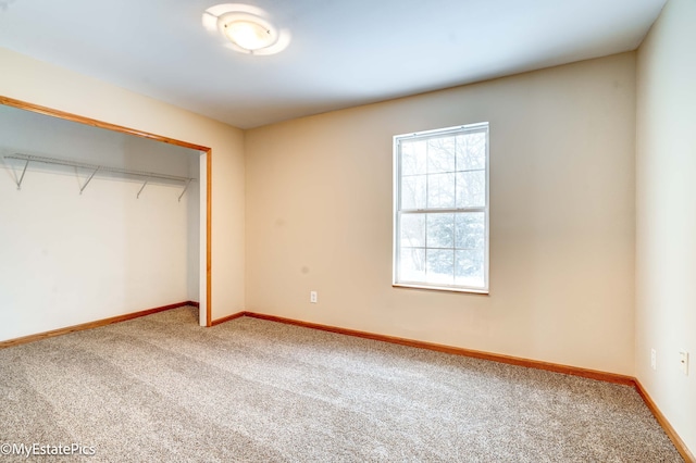 unfurnished bedroom with a closet and carpet