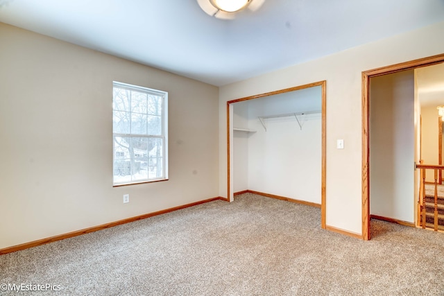 unfurnished bedroom featuring light colored carpet and a closet