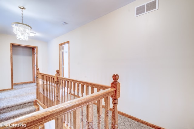 corridor featuring carpet and an inviting chandelier