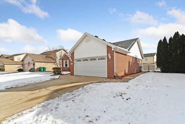 view of snowy exterior with a garage