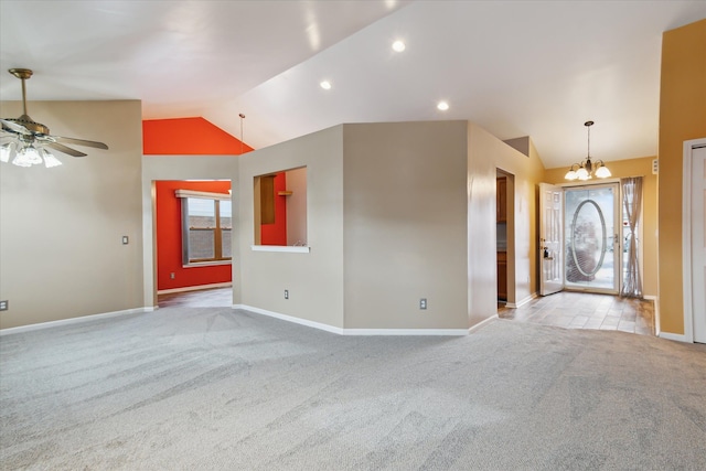 spare room with plenty of natural light, light carpet, and vaulted ceiling