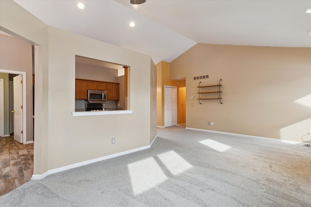 unfurnished living room featuring light carpet and vaulted ceiling