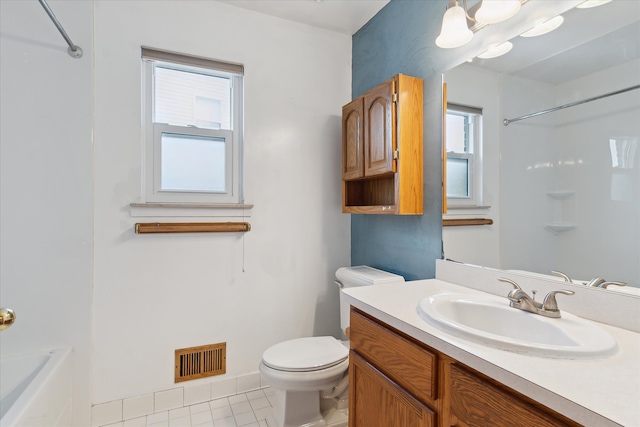 bathroom featuring tile patterned floors, vanity, toilet, and walk in shower