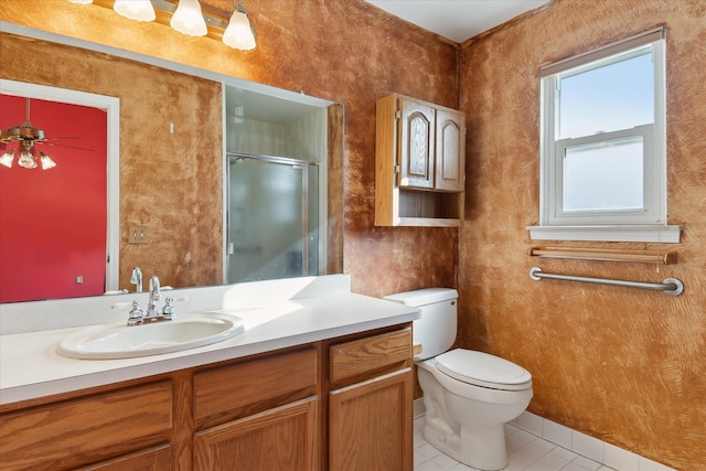 bathroom with vanity, a shower with shower door, tile patterned floors, and toilet