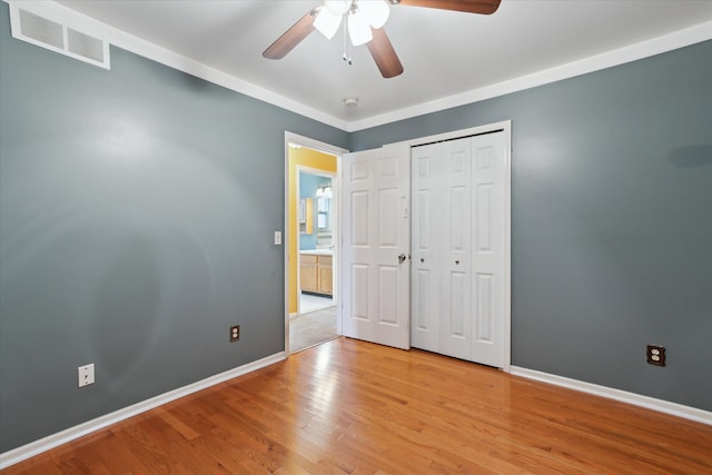 unfurnished bedroom with light hardwood / wood-style floors, a closet, and ceiling fan