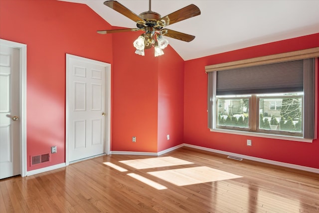 unfurnished bedroom featuring ceiling fan, light hardwood / wood-style floors, and lofted ceiling