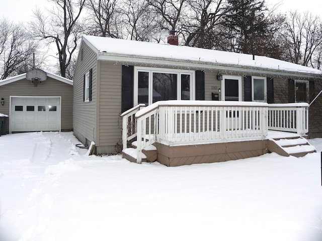 view of front facade featuring a garage and an outdoor structure