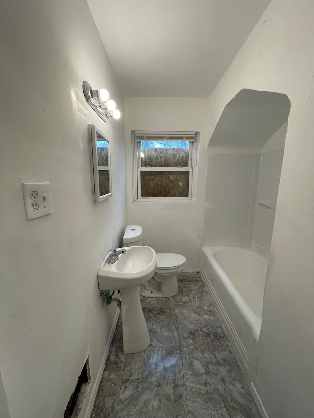 bathroom with toilet and a tub to relax in