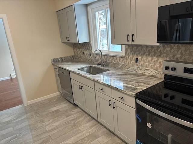 kitchen featuring stainless steel appliances, sink, light hardwood / wood-style floors, tasteful backsplash, and light stone countertops