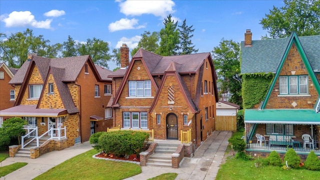 english style home featuring a front yard