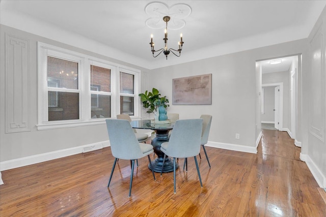 dining room featuring a notable chandelier and hardwood / wood-style floors