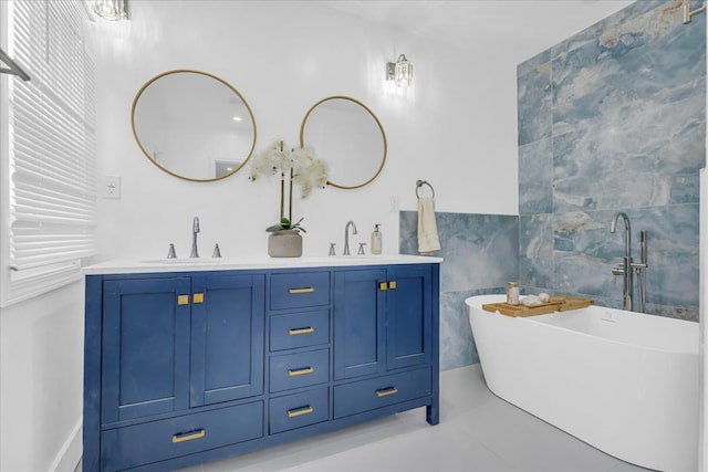 bathroom featuring vanity, tile patterned flooring, tile walls, and a bathing tub