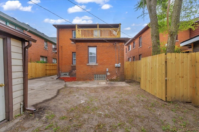 back of property featuring a balcony