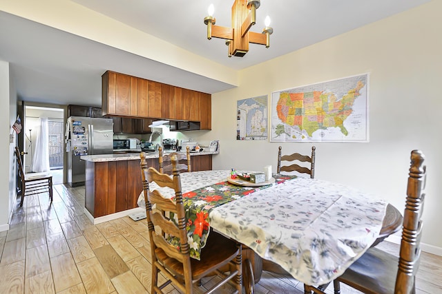 dining space featuring a notable chandelier and light hardwood / wood-style flooring