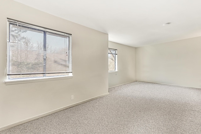 carpeted spare room with a wealth of natural light