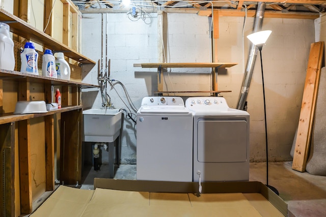 clothes washing area featuring washing machine and clothes dryer and sink