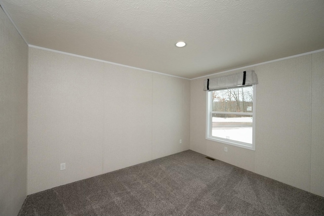 unfurnished room featuring a textured ceiling, carpet floors, and crown molding