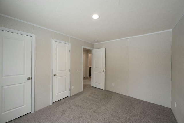 unfurnished bedroom featuring ornamental molding and light colored carpet