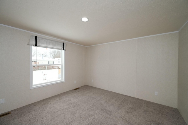 carpeted empty room with crown molding