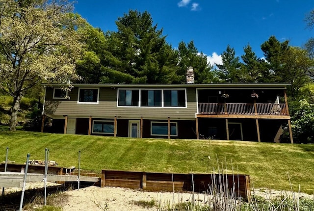 6121 S Hamlin Cir, Baldwin, MI 49304 - back of property with a chimney, a yard, and a deck