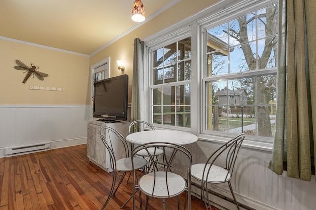 dining area featuring dark hardwood / wood-style flooring, baseboard heating, and ornamental molding