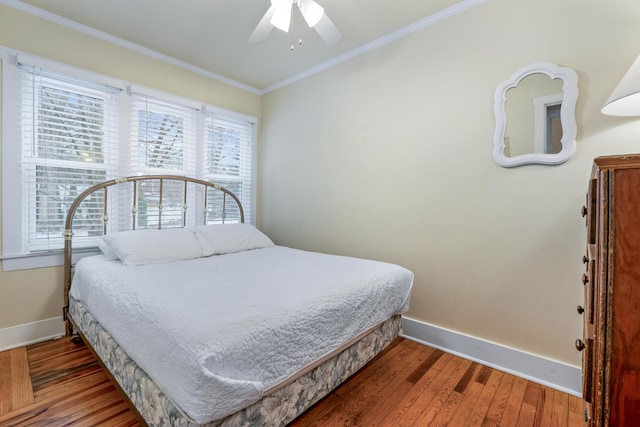 bedroom with ornamental molding, ceiling fan, and hardwood / wood-style floors