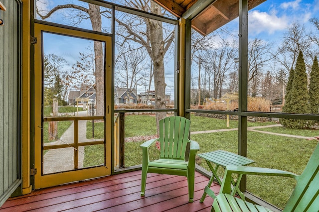 sunroom featuring vaulted ceiling