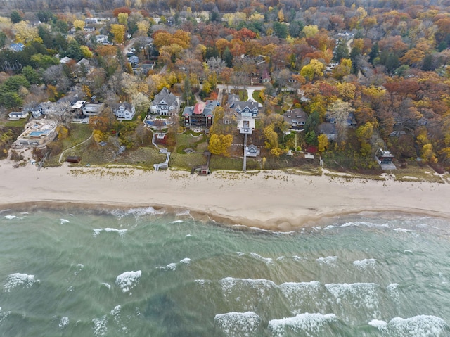 drone / aerial view featuring a water view and a view of the beach