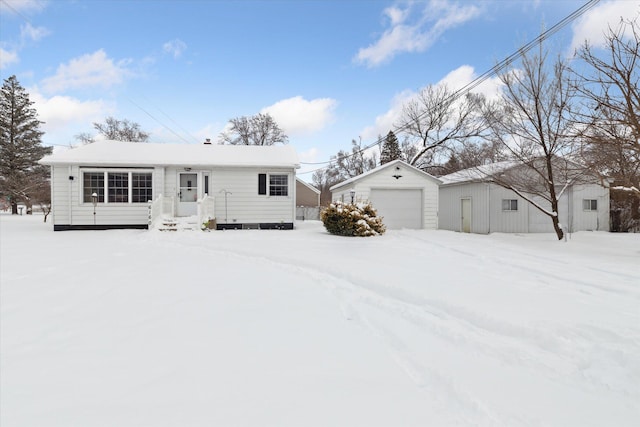 view of front of house with a garage and an outdoor structure