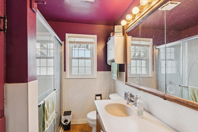 bathroom with toilet, wood-type flooring, walk in shower, and vanity