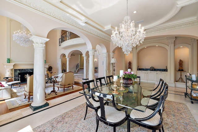 tiled dining room featuring decorative columns, a high end fireplace, ornamental molding, and a towering ceiling