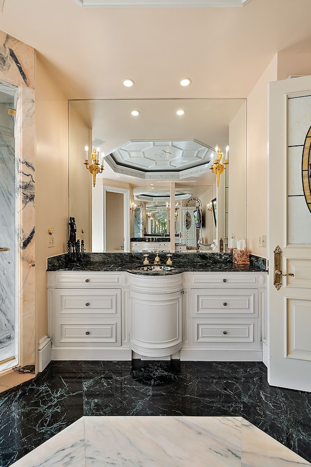 bathroom with vanity and a raised ceiling