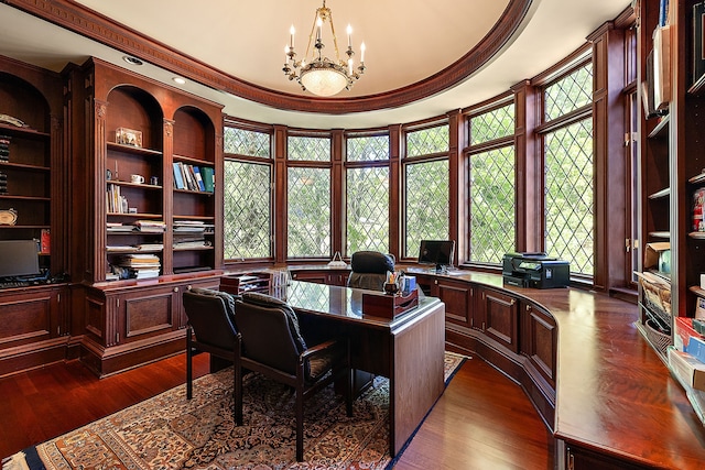 home office with dark hardwood / wood-style flooring, crown molding, and a notable chandelier