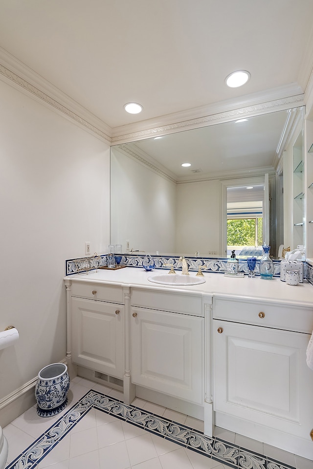 bathroom with ornamental molding, tile patterned floors, and vanity