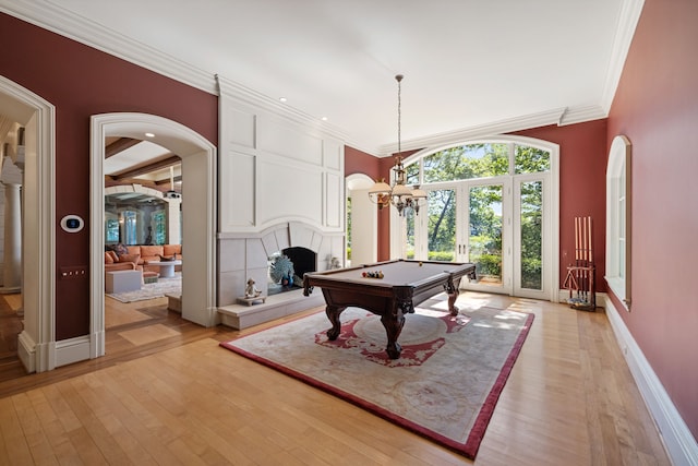 rec room featuring french doors, ornamental molding, light hardwood / wood-style flooring, and billiards