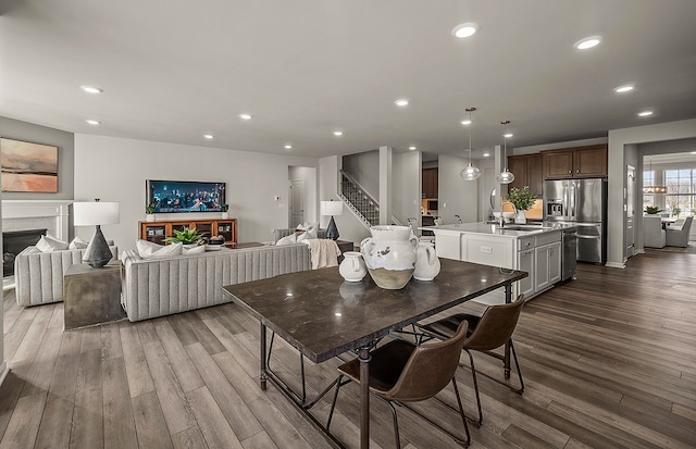 dining space featuring sink and dark wood-type flooring