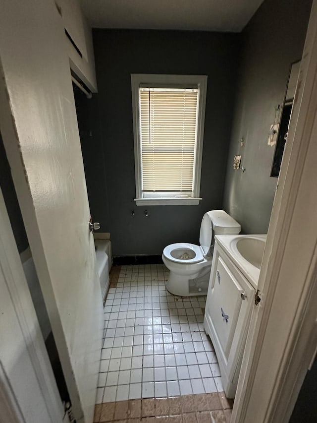 bathroom featuring toilet, vanity, and tile patterned floors