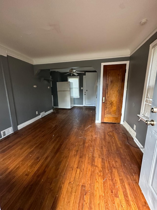 unfurnished living room with ceiling fan, crown molding, and hardwood / wood-style flooring