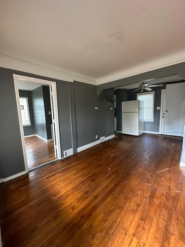 unfurnished living room with ceiling fan and wood-type flooring