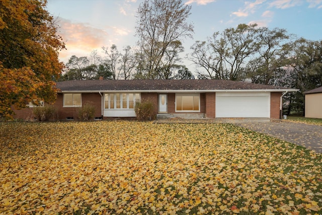 ranch-style home with a lawn and a garage