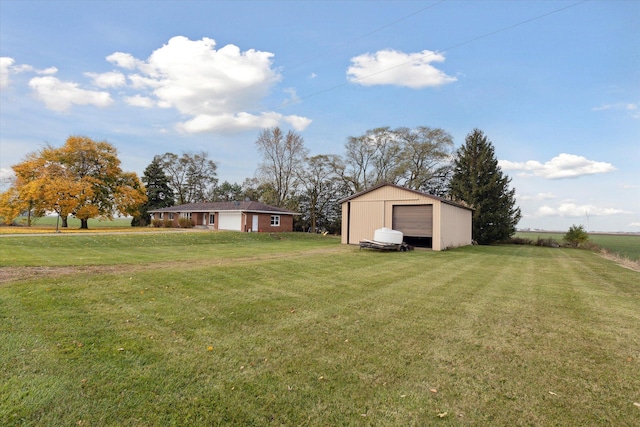 view of yard with a garage and an outdoor structure