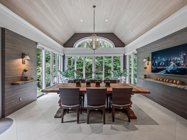 tiled dining room featuring wooden walls, wooden ceiling, an inviting chandelier, and high vaulted ceiling