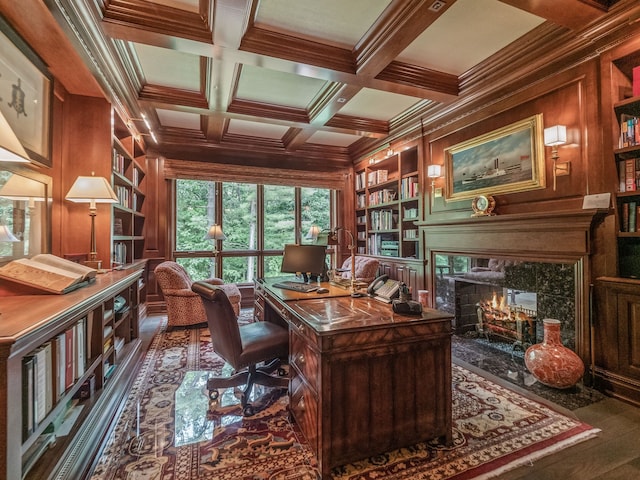 office area with wood walls, ornamental molding, and built in features