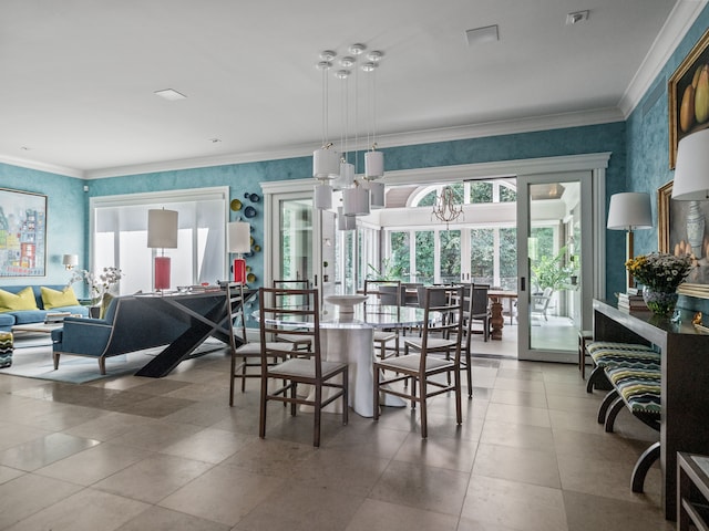 dining space featuring a healthy amount of sunlight, a notable chandelier, and crown molding